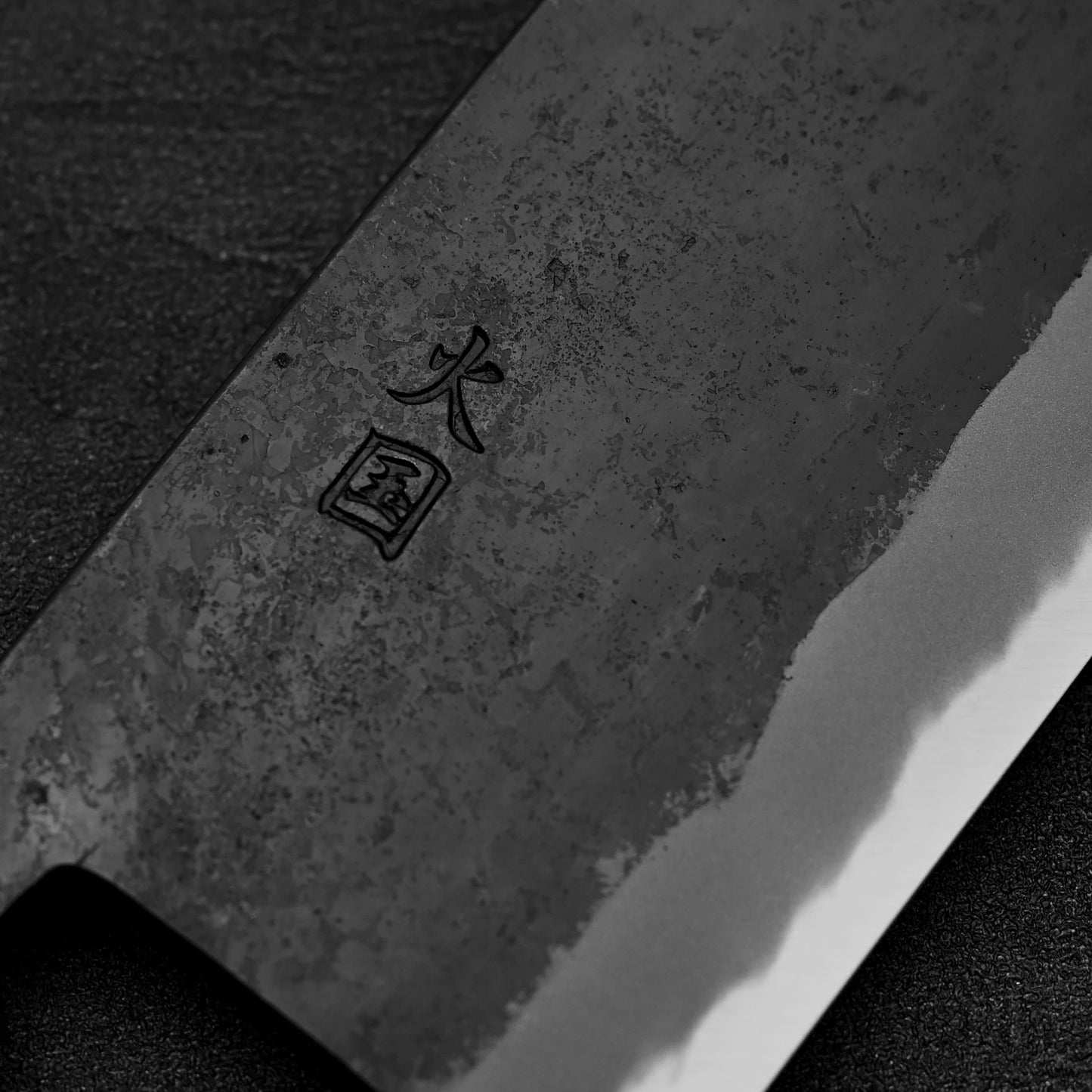Close up view of the kanji of Hinokuni kurouchi shirogami#1 chuka bocho knife