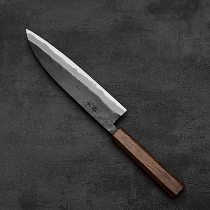 Top down view of Hinokuni kurouchi shirogami#1 gyuto knife in diagonal position