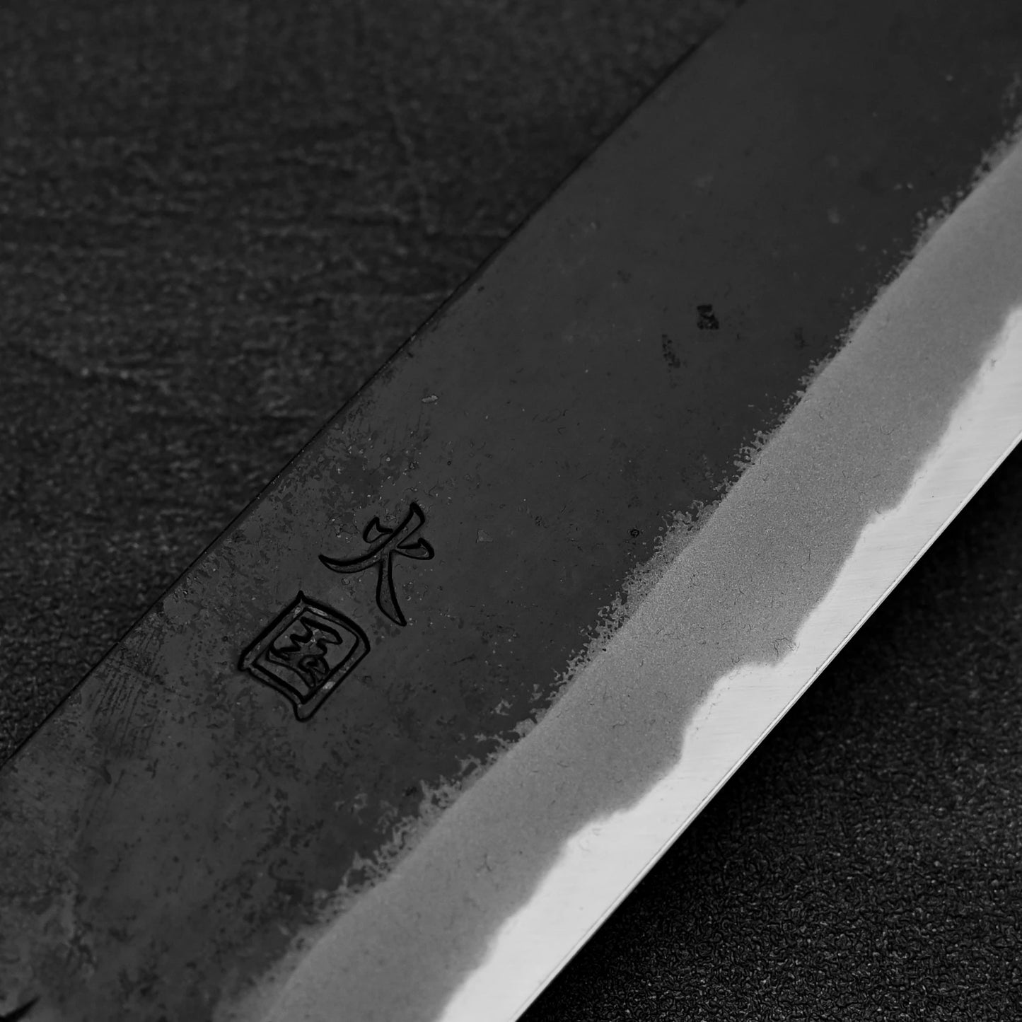 Close up of the kanji of Hinokuni kurouchi shirogami#1 gyuto knife