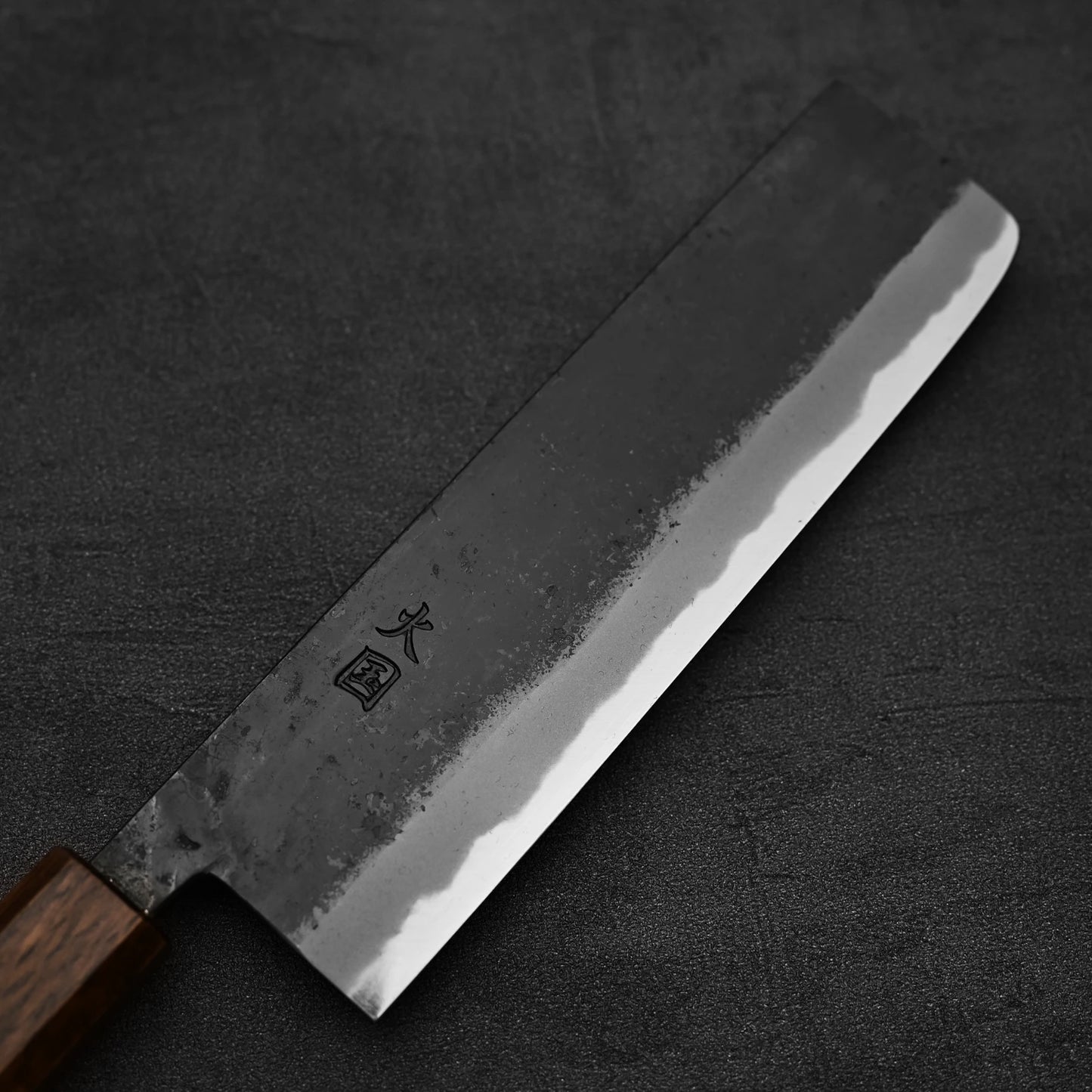 Close up view of the blade of Hinokuni kurouchi shirogami#1 nakiri knife