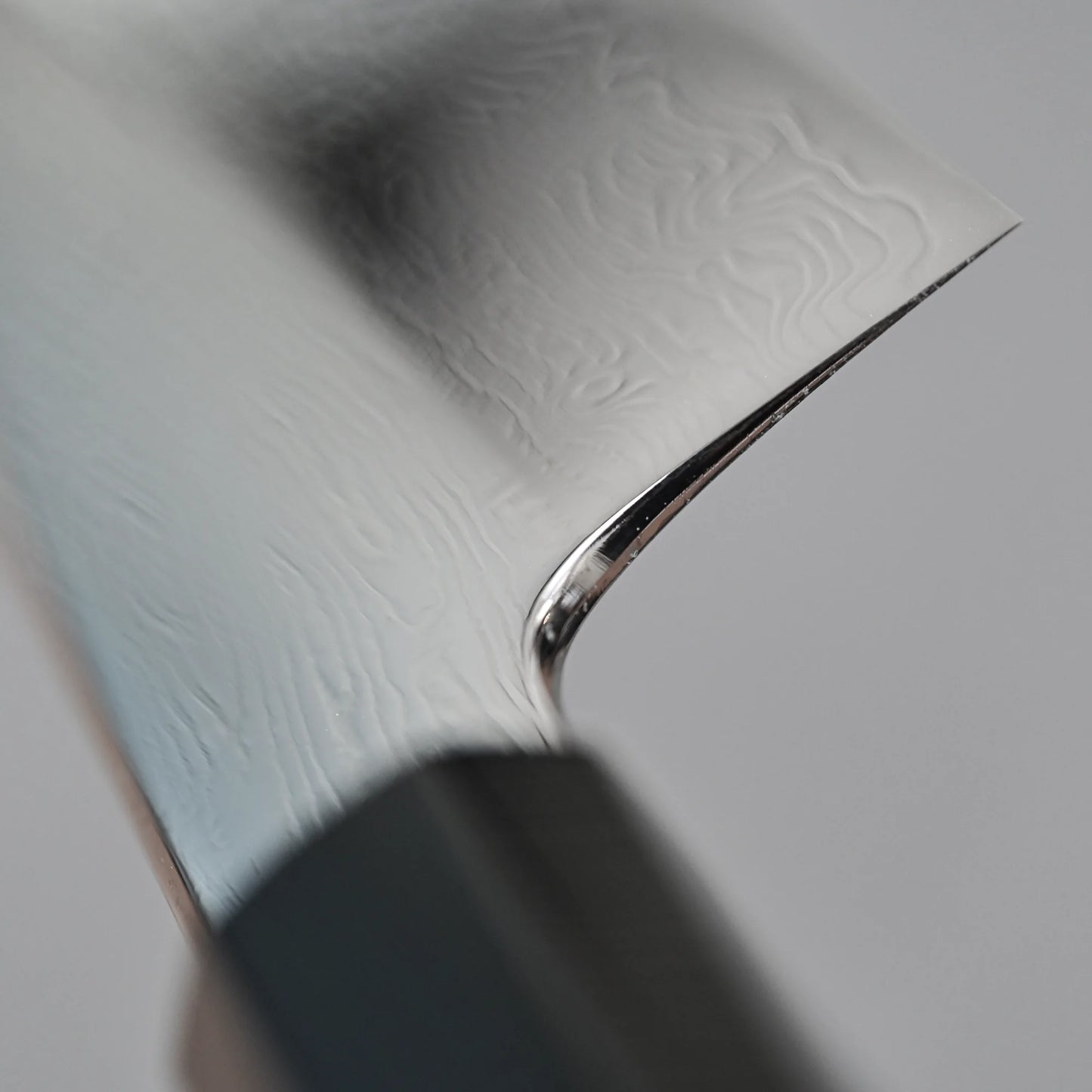 Close-up shot of the choil finish of 210mm Nakagawa SPG STRIX damascus gyuto knife