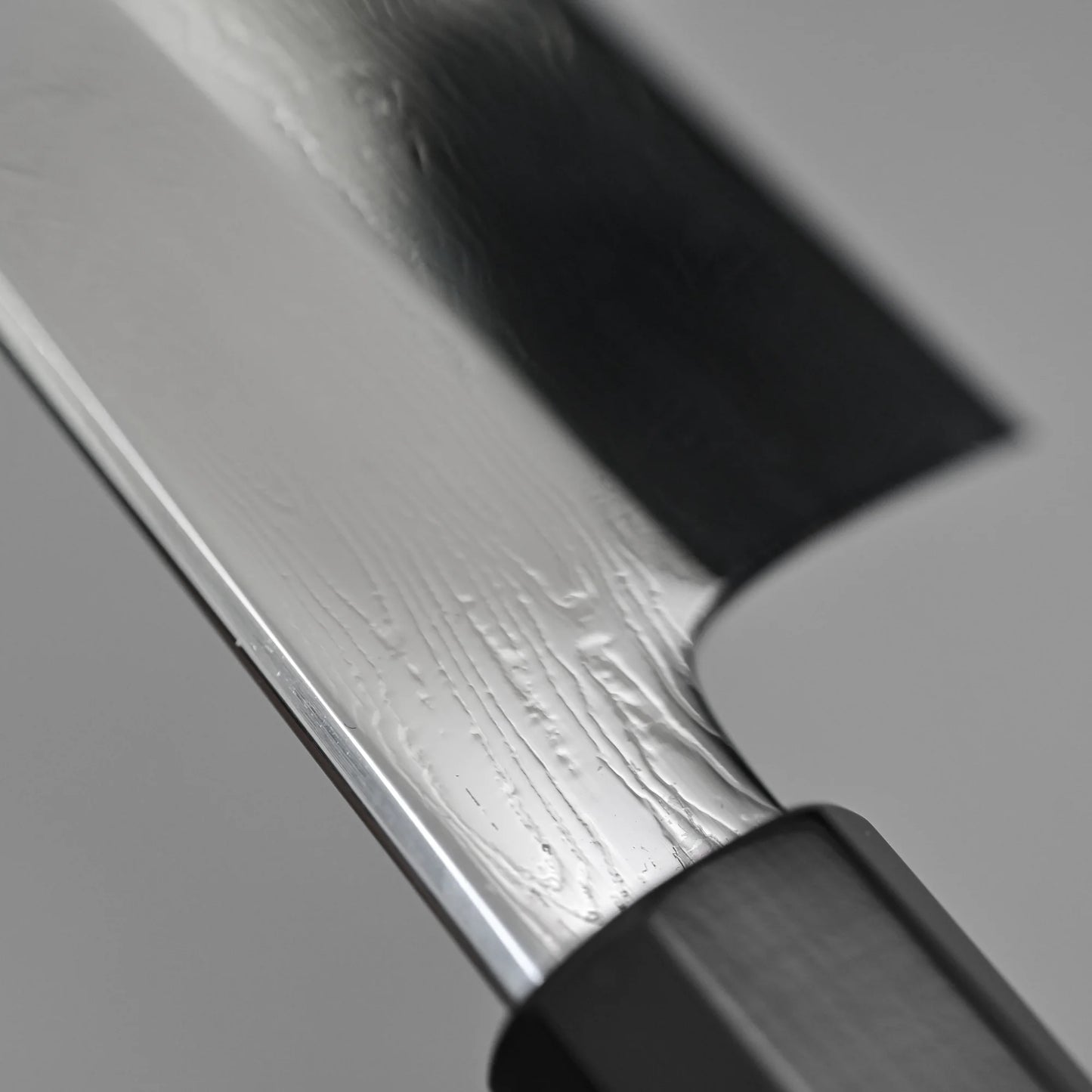 Close-up shot of the spine finish of 210mm Nakagawa SPG STRIX damascus gyuto knife