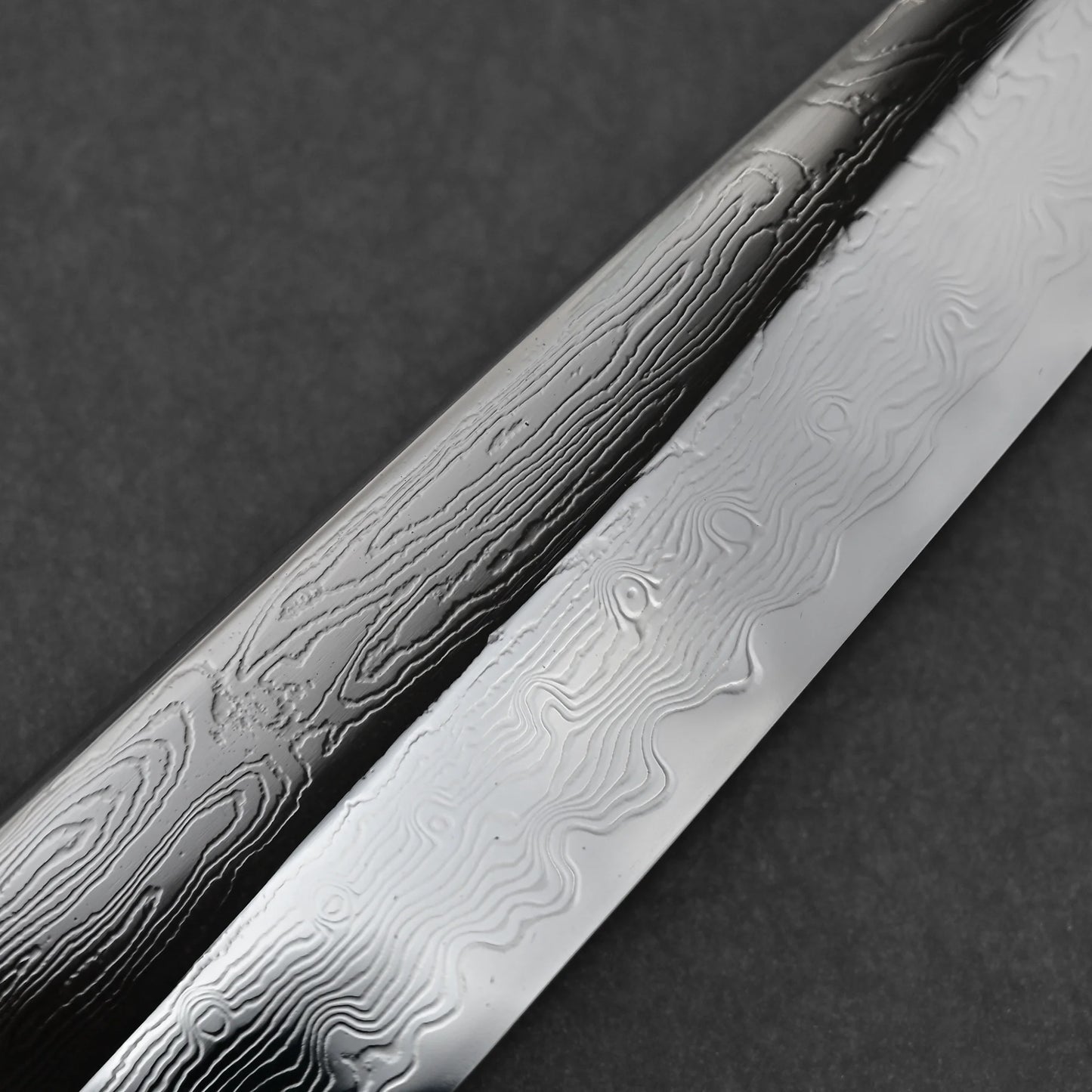 Close up shot of the damascus pattern of 210mm Nakagawa SPG STRIX damascus gyuto knife