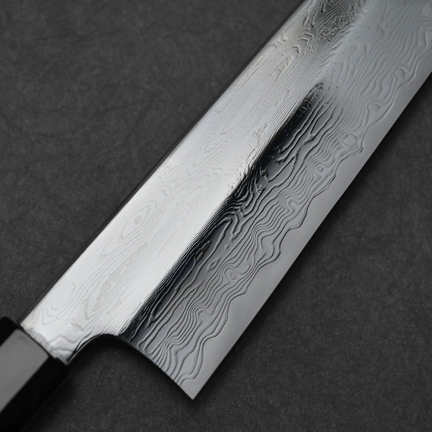 Close-up shot of the damascus pattern of 240mm Nakagawa SPG STRIX damascus gyuto knife