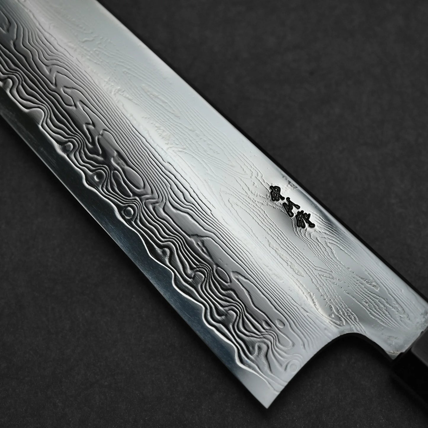 Close-up shot of the maker's mark of 240mm Nakagawa SPG STRIX damascus gyuto knife