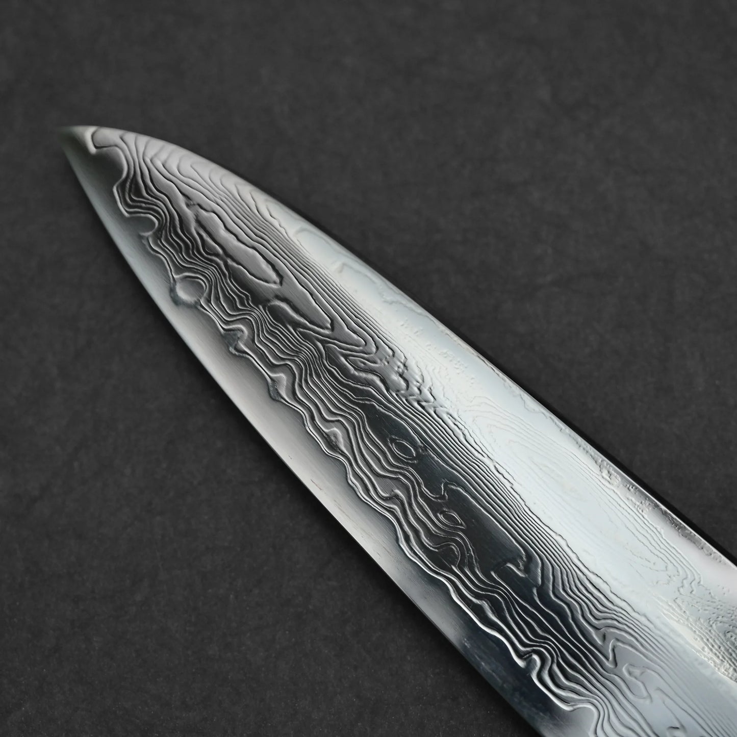 Close-up shot of the tip area on the left side of 240mm Nakagawa SPG STRIX damascus gyuto knife