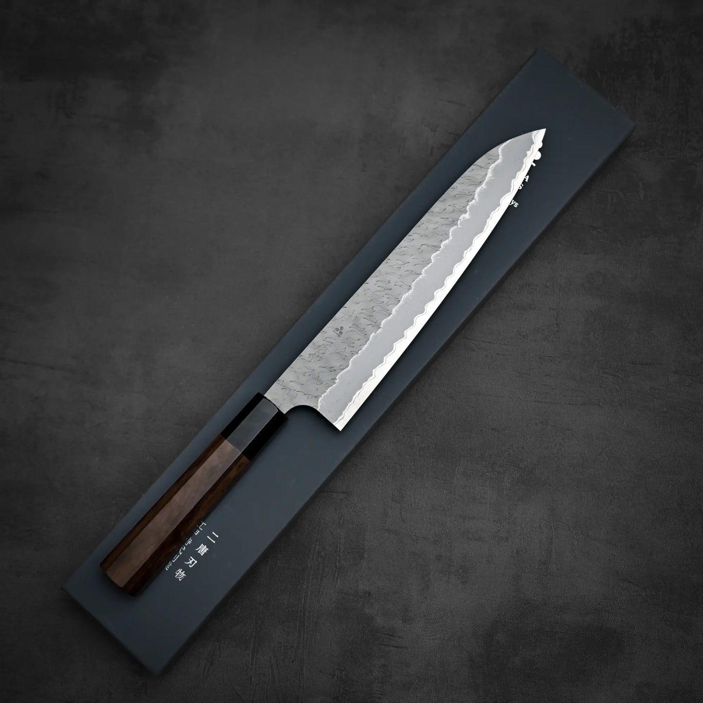 Top down view of Nigara tsuchime AS gyuto knife with its box