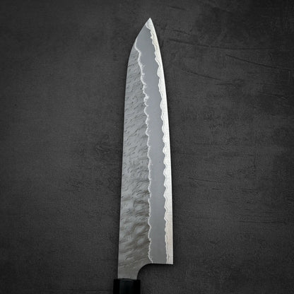 Close up view of the front blade of Nigara tsuchime AS gyuto knife in vertical position