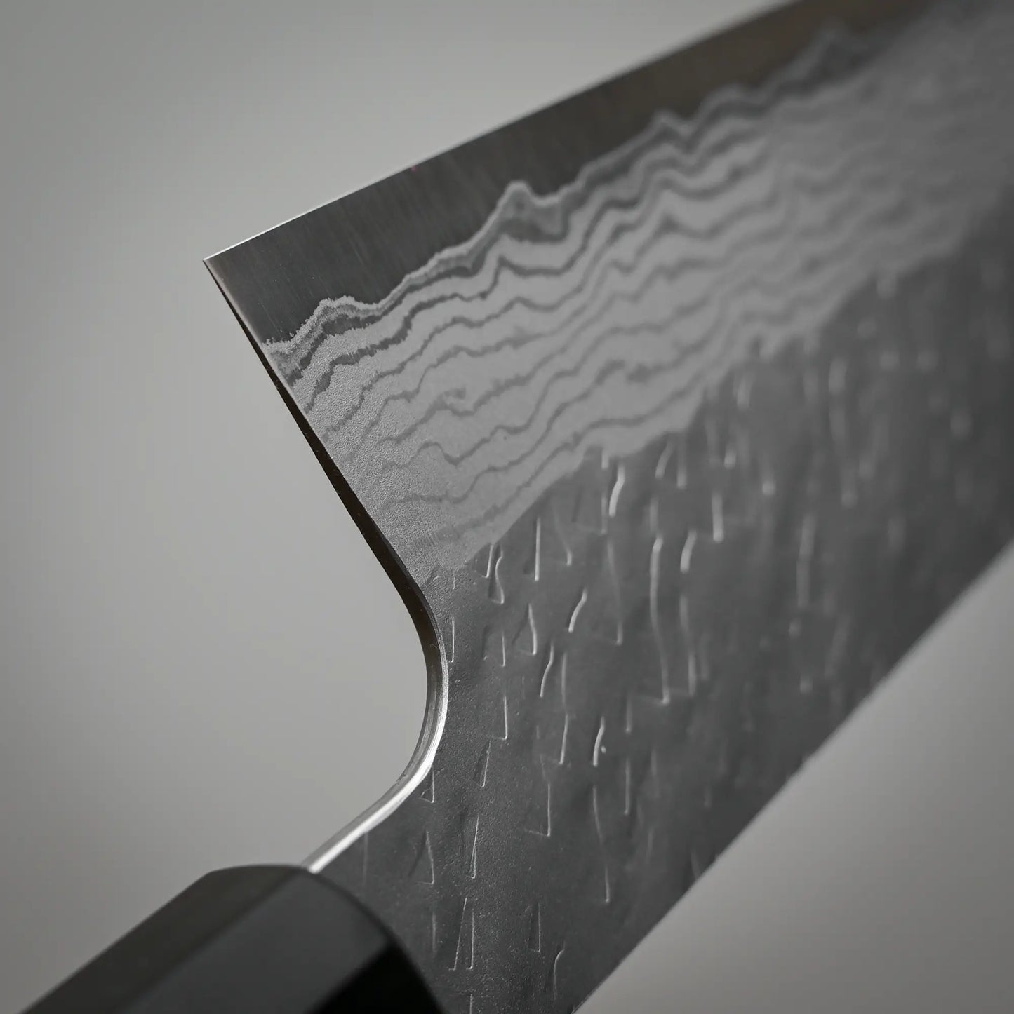 Close-up view of the choil of 210mm Nigara tsuchime damacsus VG10 gyuto knife