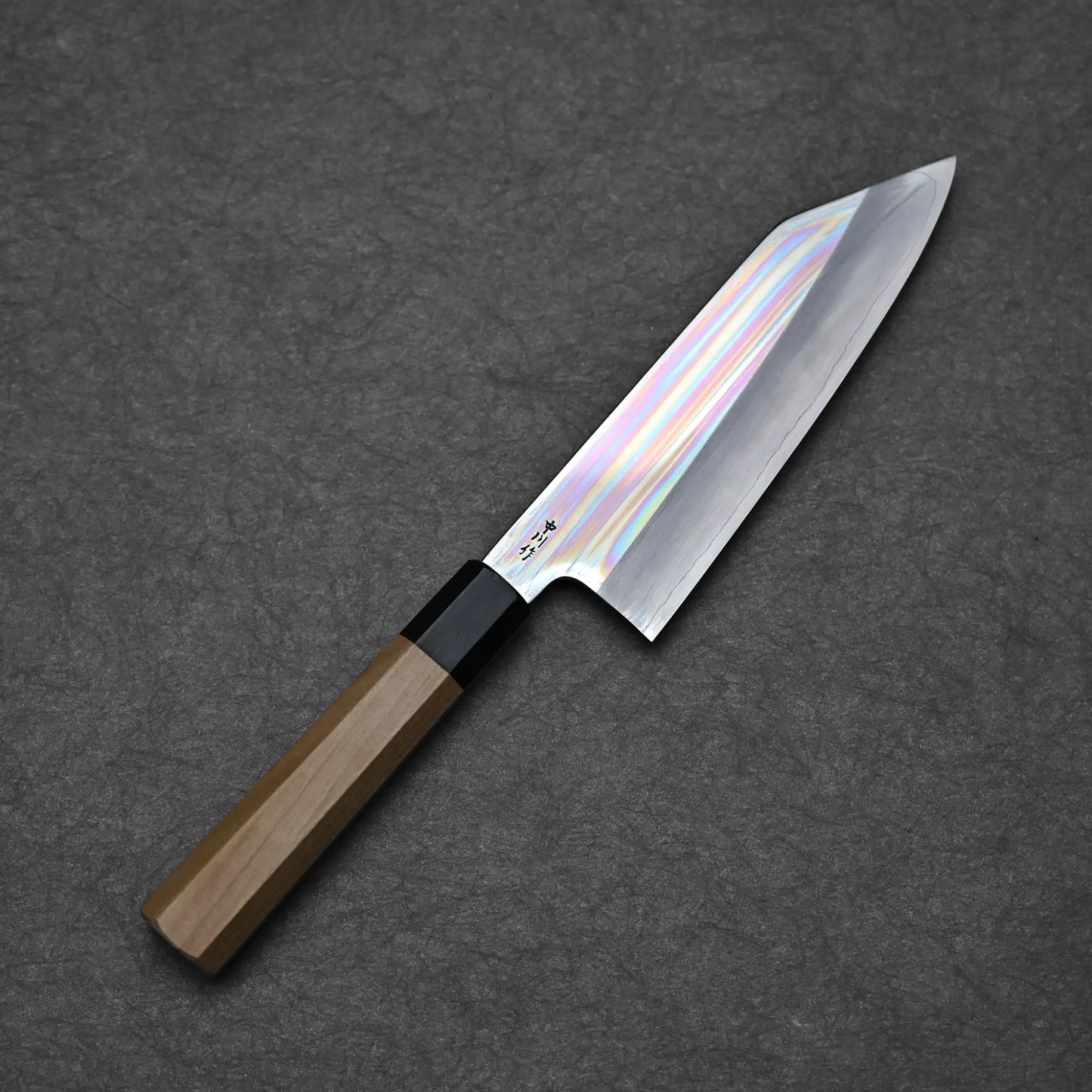 Full blade profile of Nakagawa ginsan bunka 170mm with mirror polished hira and octagonal magnolia handle against dark background