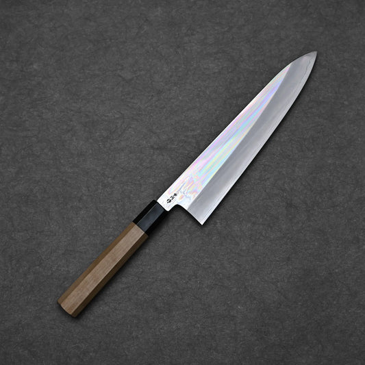 Full blade profile of Nakagawa ginsan tall gyuto 240mm with mirror polished hira and octagonal magnolia handle against dark background
