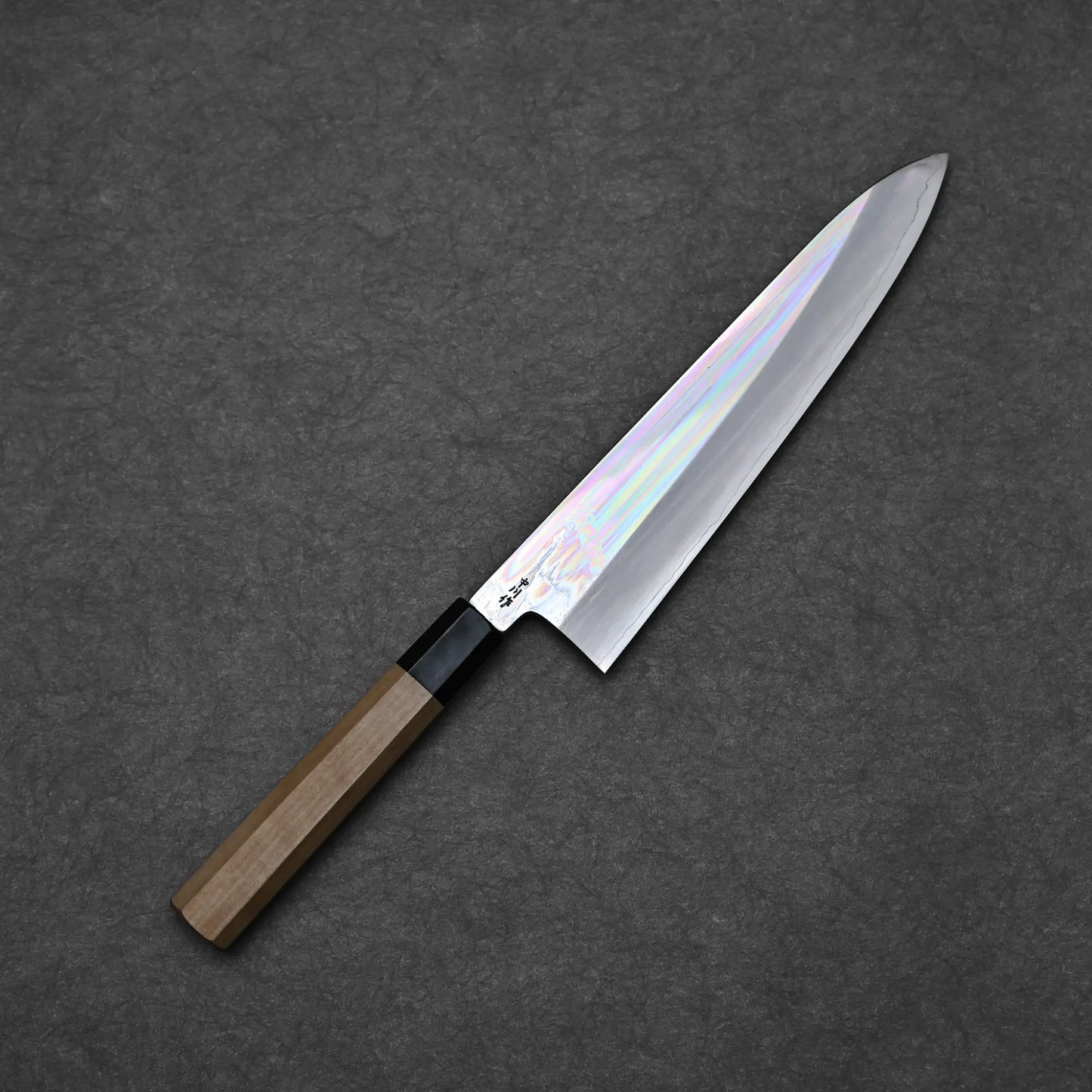 Full blade profile of Nakagawa ginsan tall gyuto 240mm with mirror polished hira and octagonal magnolia handle against dark background 