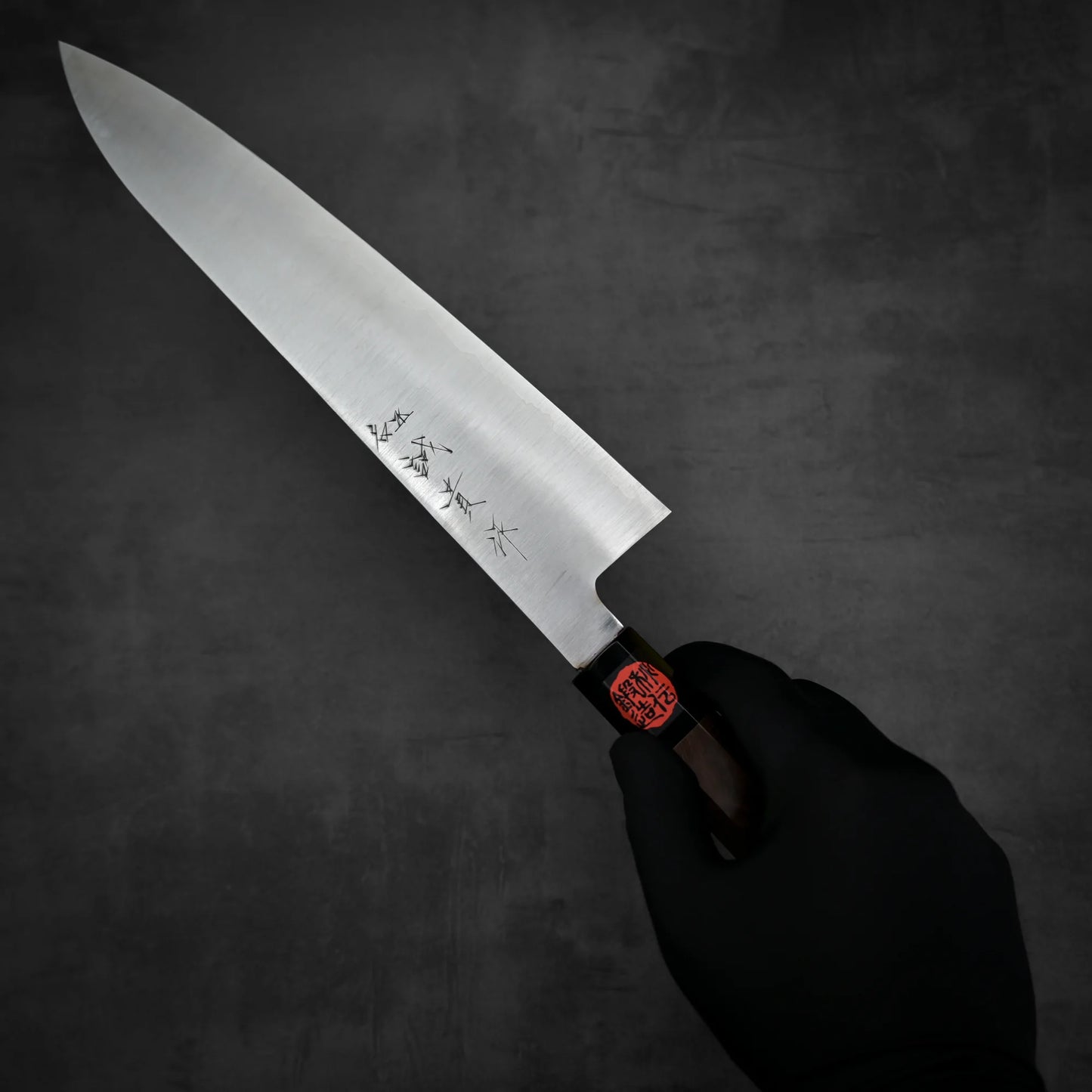 Top down view of Shigeki Tanaka ginsan gyuto knife held in hand