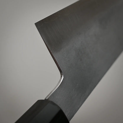 Close-up view of the choil of 240mm Shigeki Tanaka nashiji ginsan gyuto knife