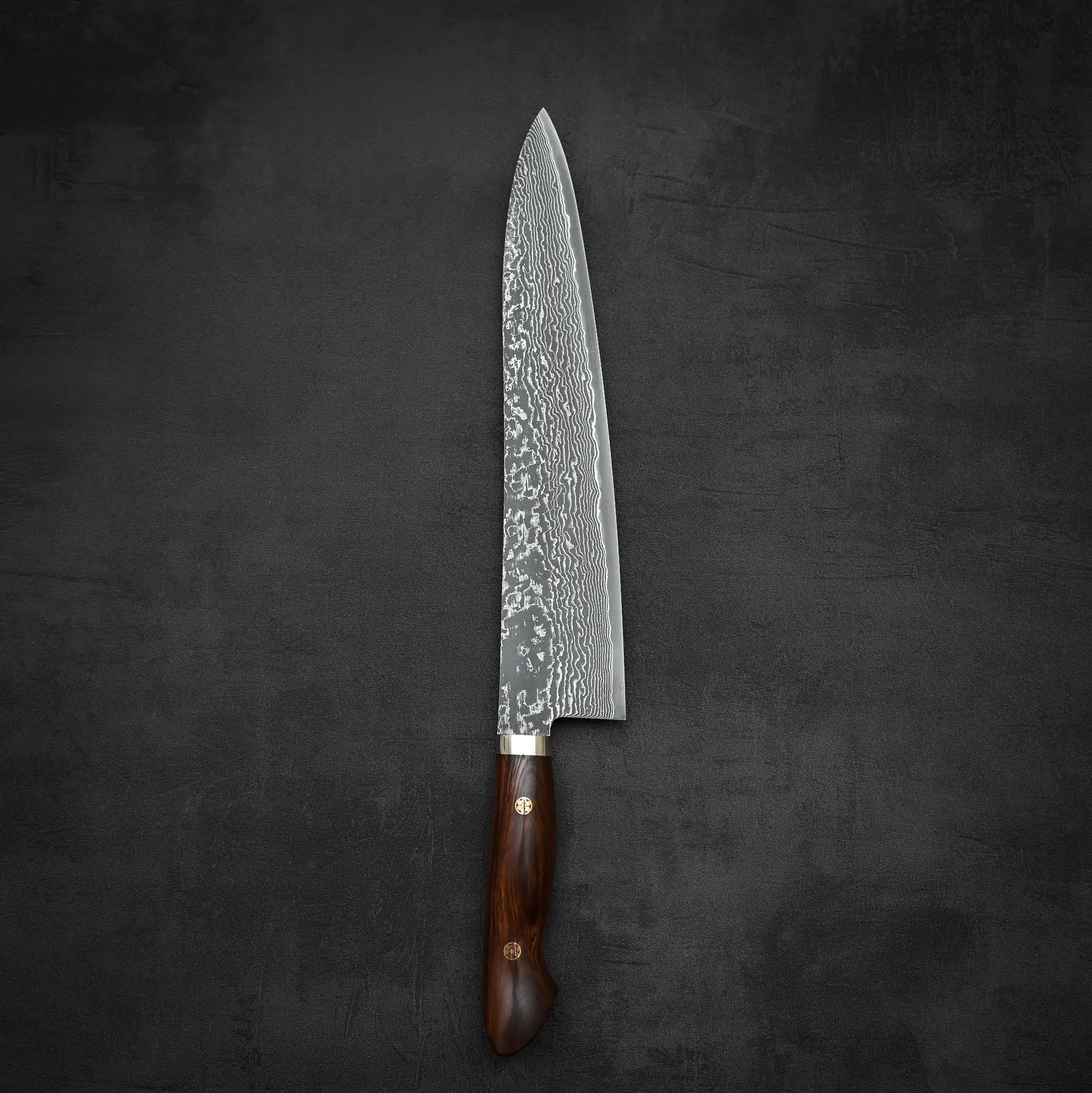 Top down view of 270mm Shigeki Tanaka R2 damascus ironwood gyuto knife in vertical position