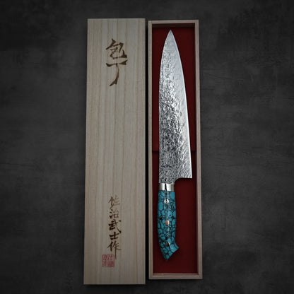 Top down view of Takeshi Saji R2 diamond damascus gyuto knife in vertical position