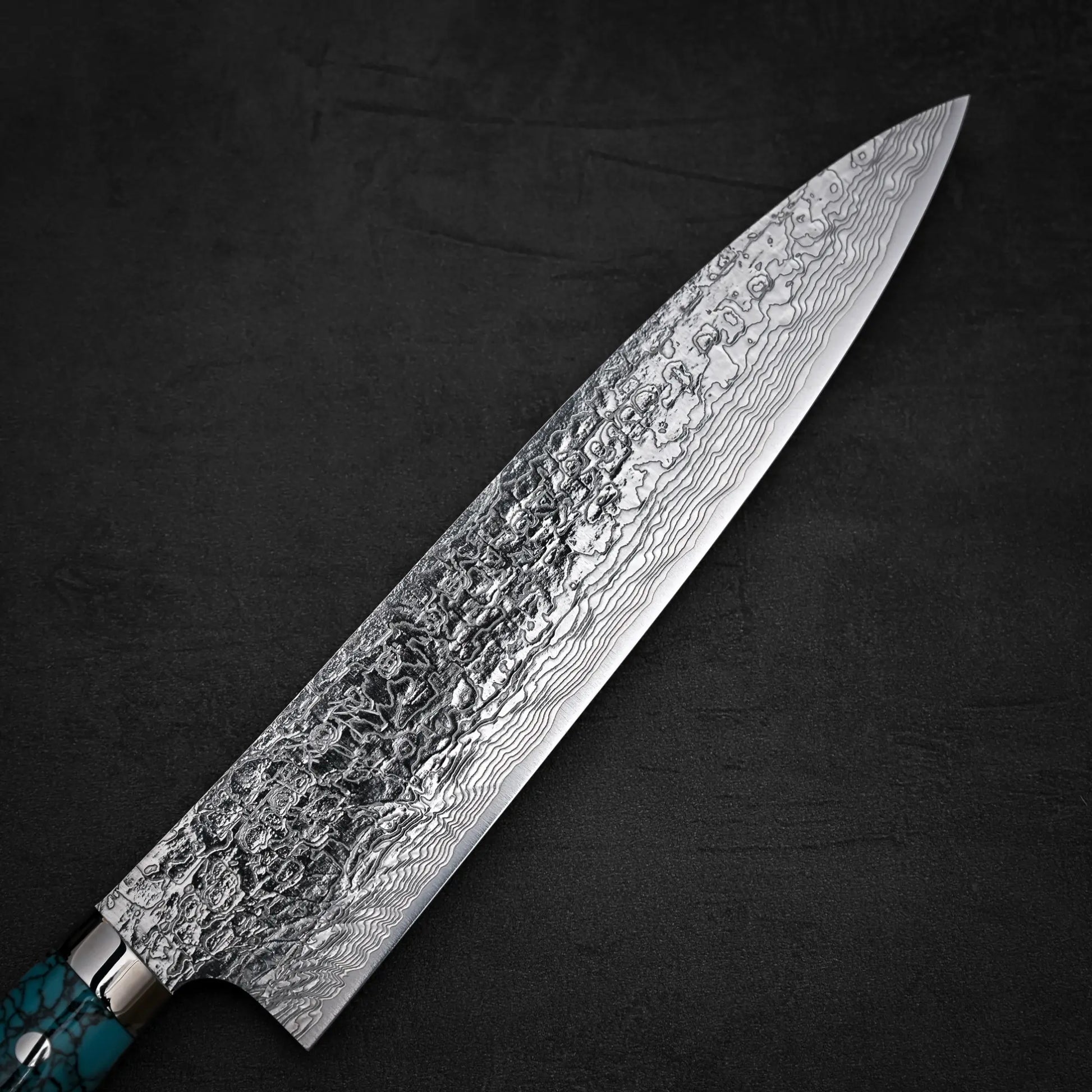 Close up view of the front side of Takeshi Saji R2 diamond damascus gyuto knife