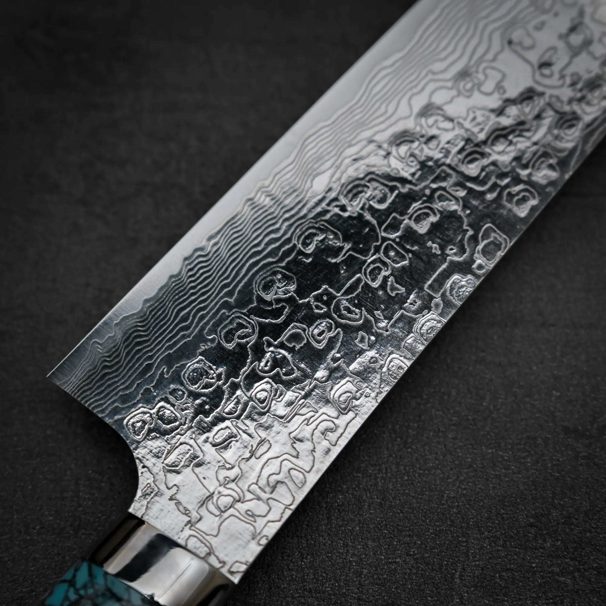 Close up shot of the back side of Takeshi Saji R2 diamond damascus gyuto knife