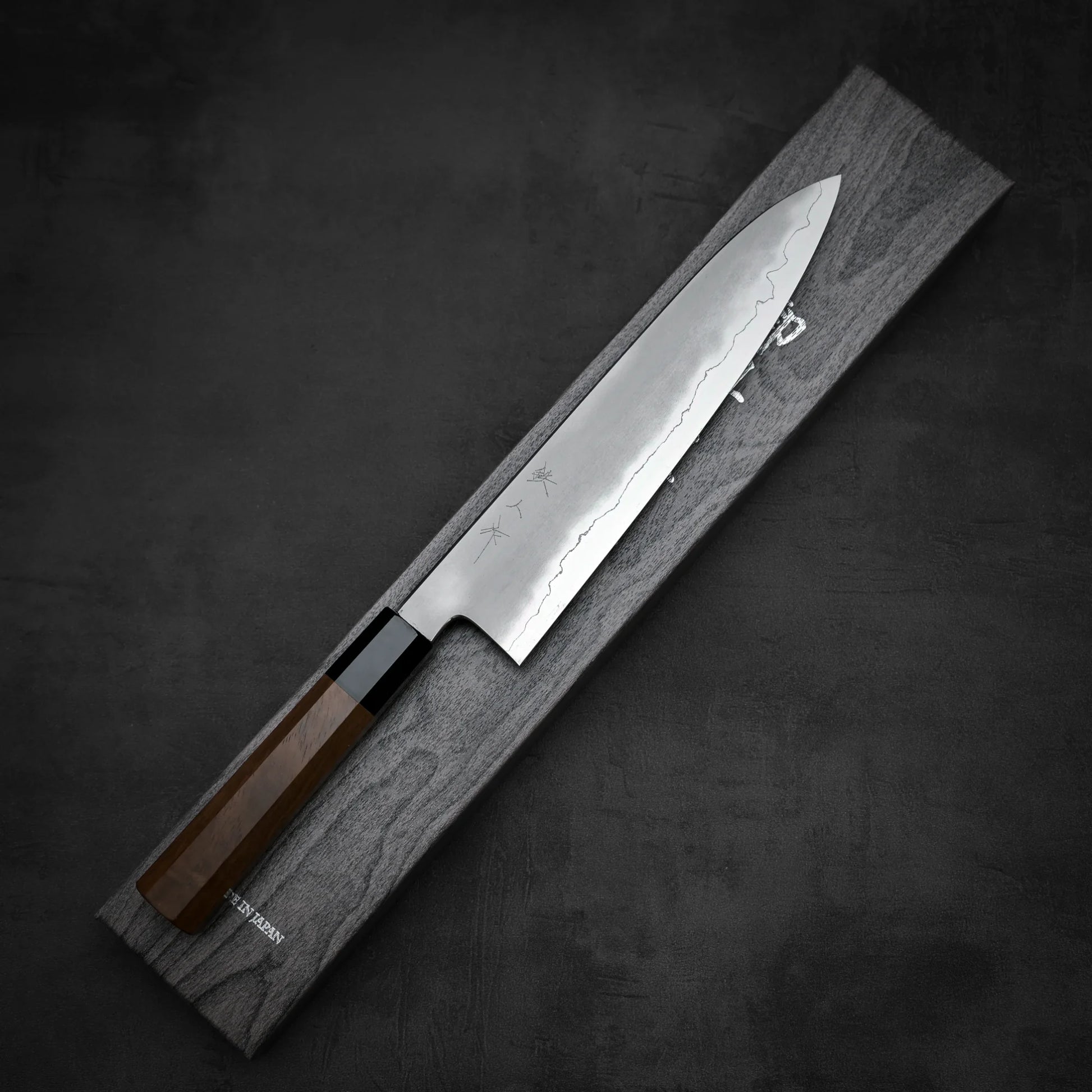 Top down view of Tetsujin kasumi ginsan gyuto knife with its box