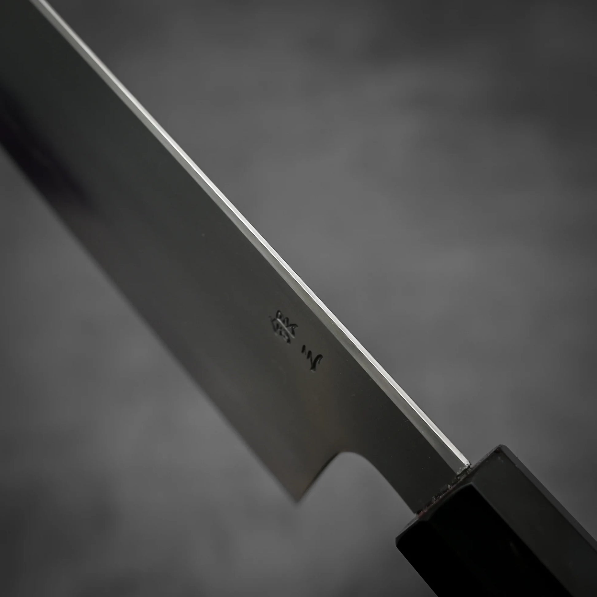 Macro shot of the spine area of Tetsujin kasumi ginsan gyuto knife