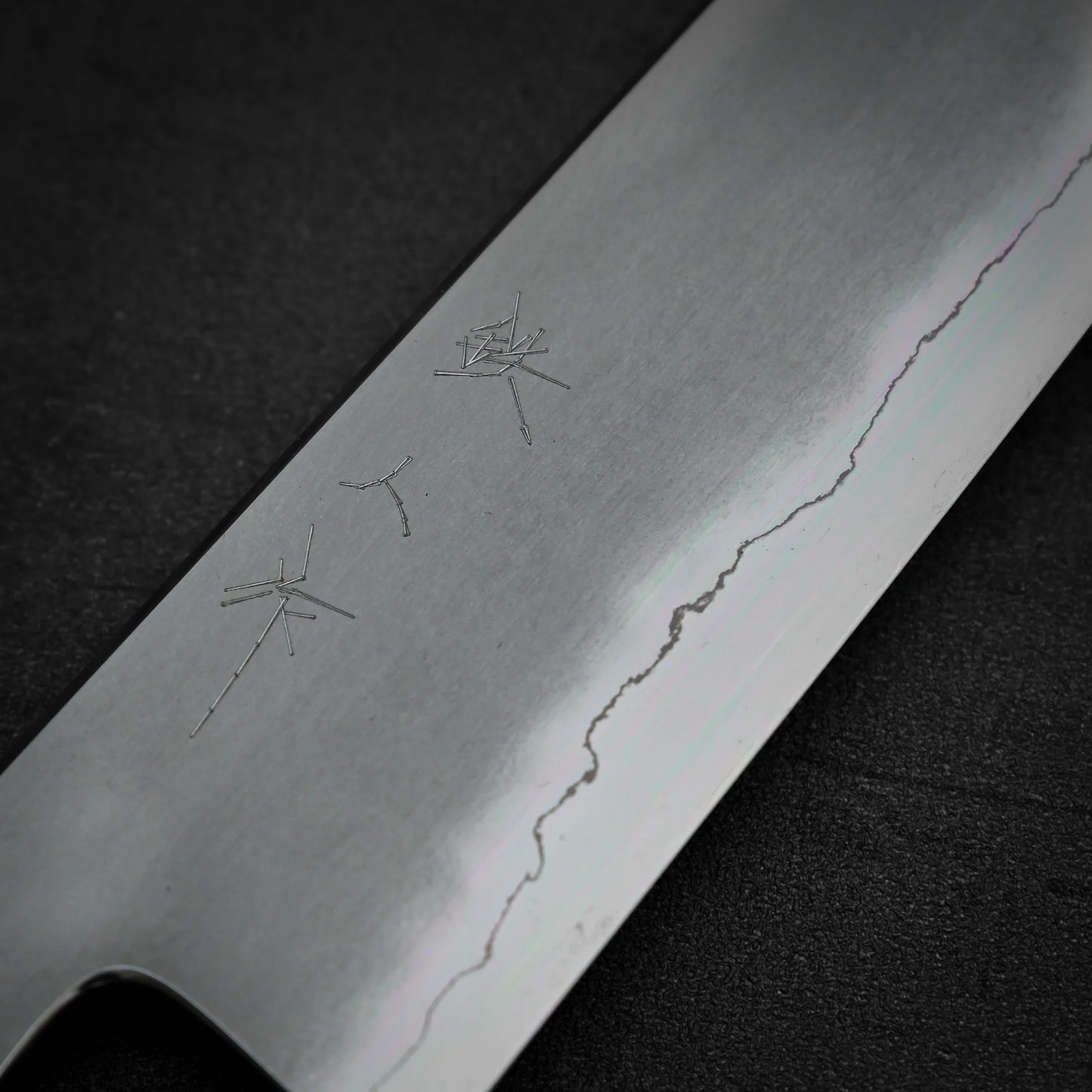 Macro shot of the kanji area of Tetsujin kasumi ginsan gyuto knife