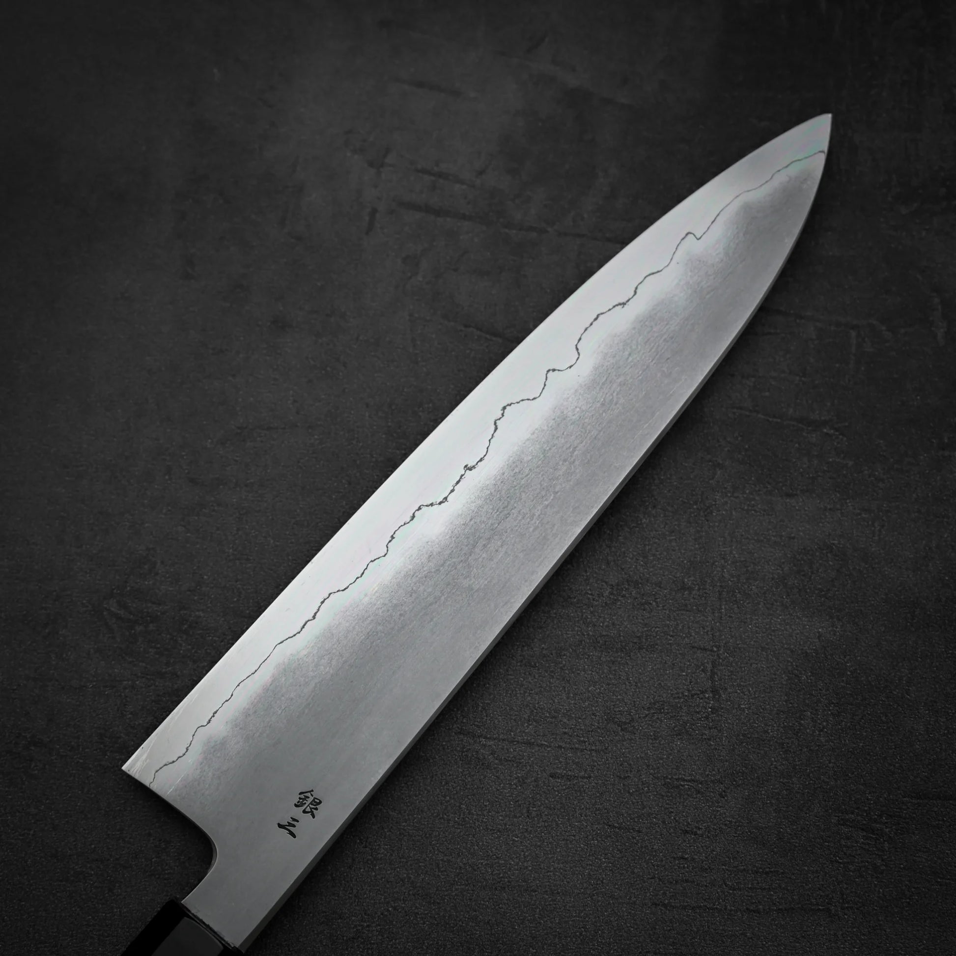 Close up view of the back side of Tetsujin kasumi ginsan gyuto knife