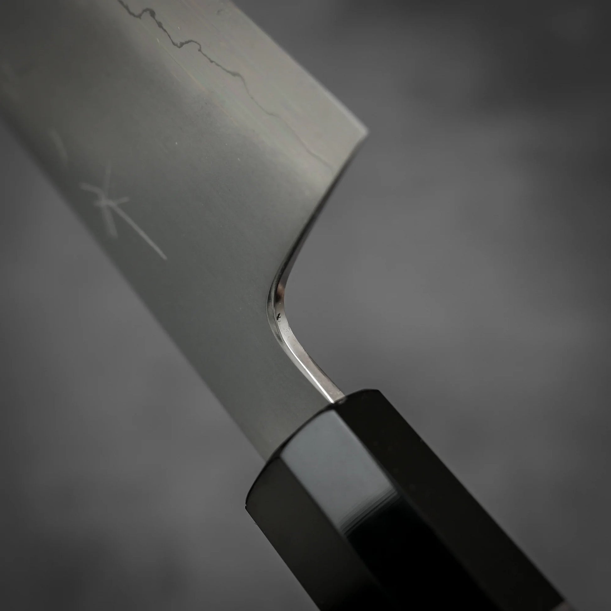 Macro shot of the choil area of Tetsujin kasumi ginsan gyuto knife