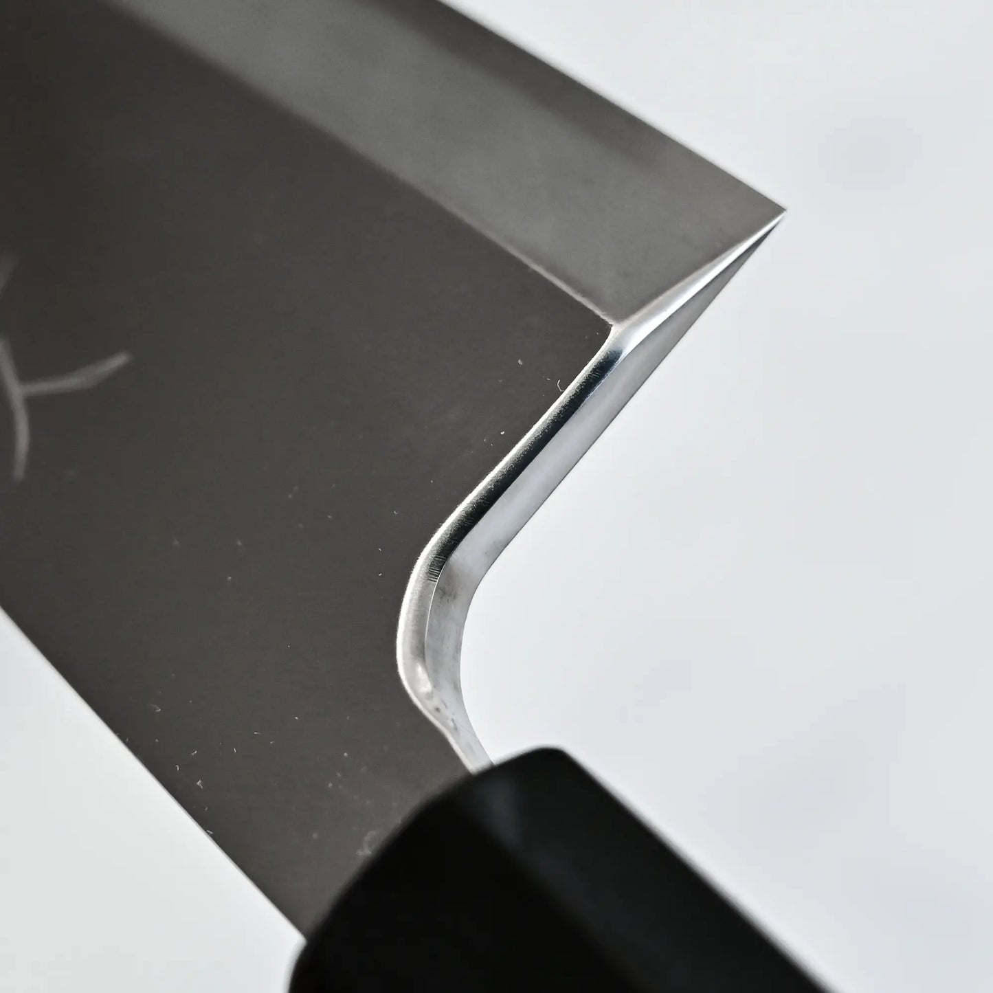 Close-up shot of the high polish on the choil of Tsunehisa knife ginsan 180mm deba