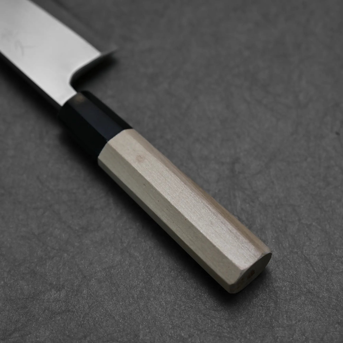 Close-up shot of the handle of Tsunehisa knife ginsan 165mm deba