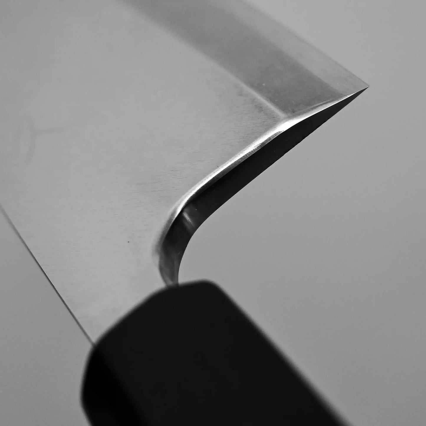 Close-up shot of the high polish on the choil of Tsunehisa knife ginsan 165mm deba