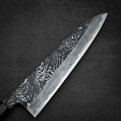 Close up view of the front blade of Yoshihide Masuda shirogami#2 kurouchi damascus tall gyuto knife