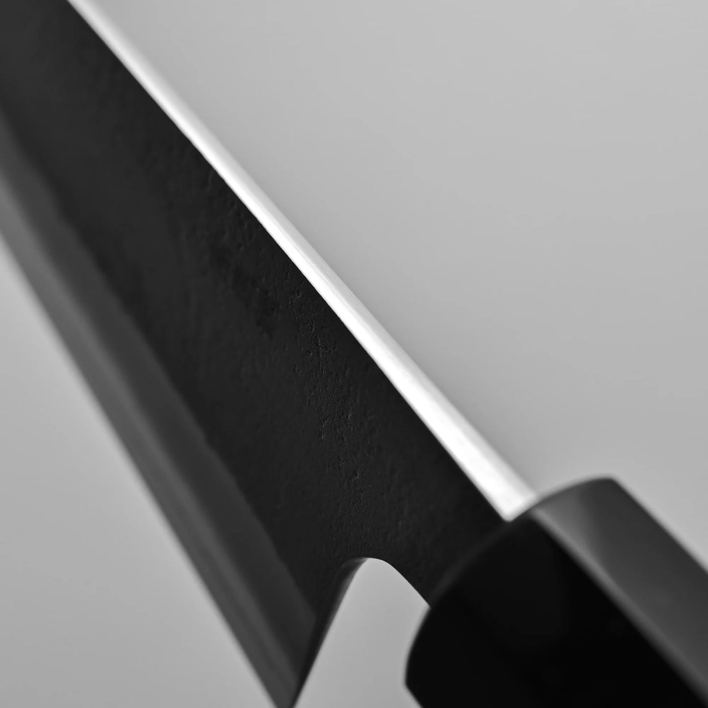 Close-up view of the spine of 240mm Hatsukokoro x Yoshikane nashiji SKD gyuto knife