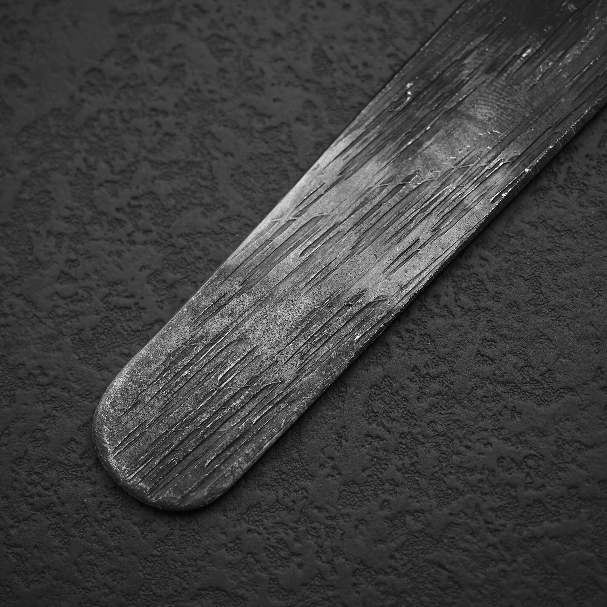 Close up view of Kiridashi AS 24mm. Image focuses on the bottom part of the blade