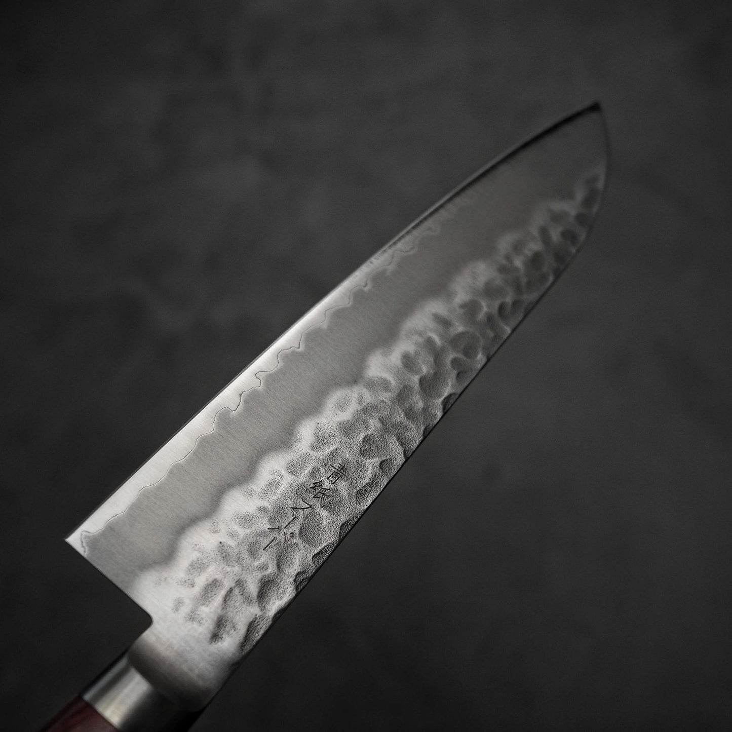 Top view of Tsunehisa tsuchime aogami super santoku 180mm. Image shows the left side of the knife.