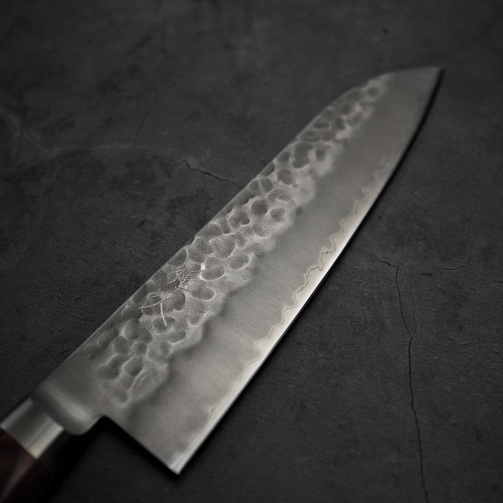 Top view of the blade of Tsunehisa tsuchime aogami super santoku 180mm. Image focuses on the right side of the knife.