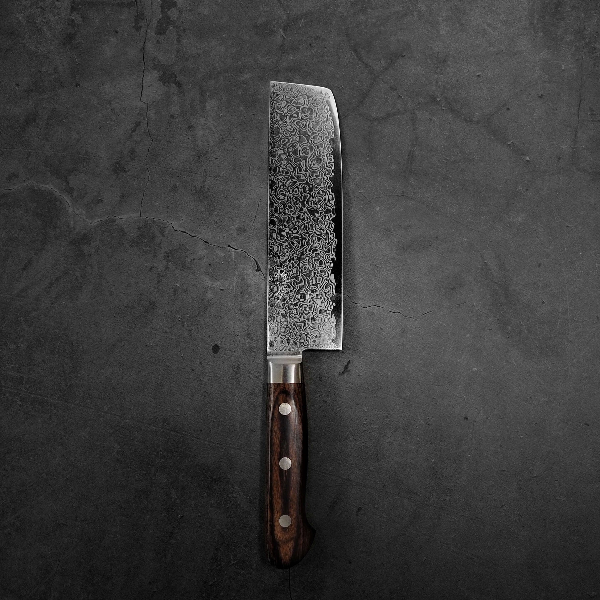 Top view of Tsunehisa ZA18 damascus nakiri knife in vertical position